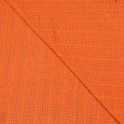 Close-up of orange fabric with a diagonal seam