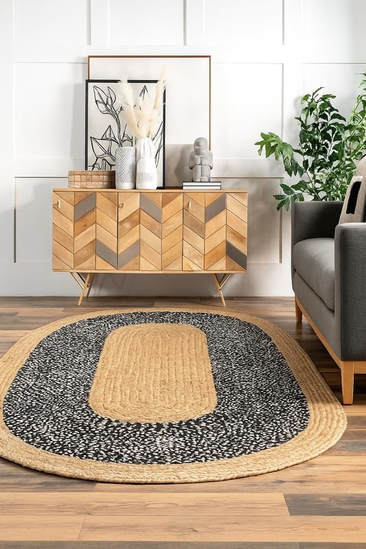Living room with wooden sideboard, gray sofa, and round rug with geometric pattern.