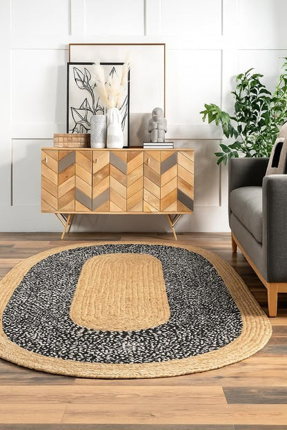 Living room with wooden sideboard, gray sofa, and round rug with geometric pattern.