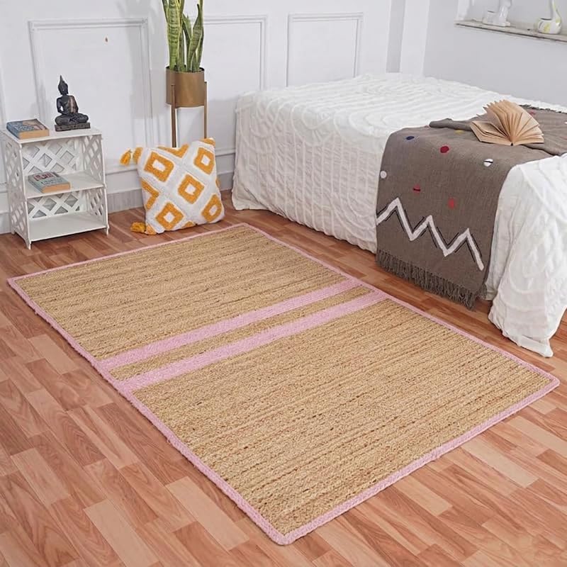 Natural Jute Area Rug floor carpet with pink border in bedroom on hardwood floor