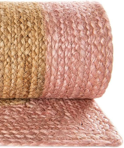 Handwoven natural jute rug in pink and beige, durable and stylish for home decor.