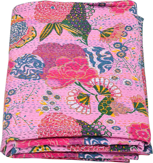 Folded floral quilt with vibrant colors on a white background