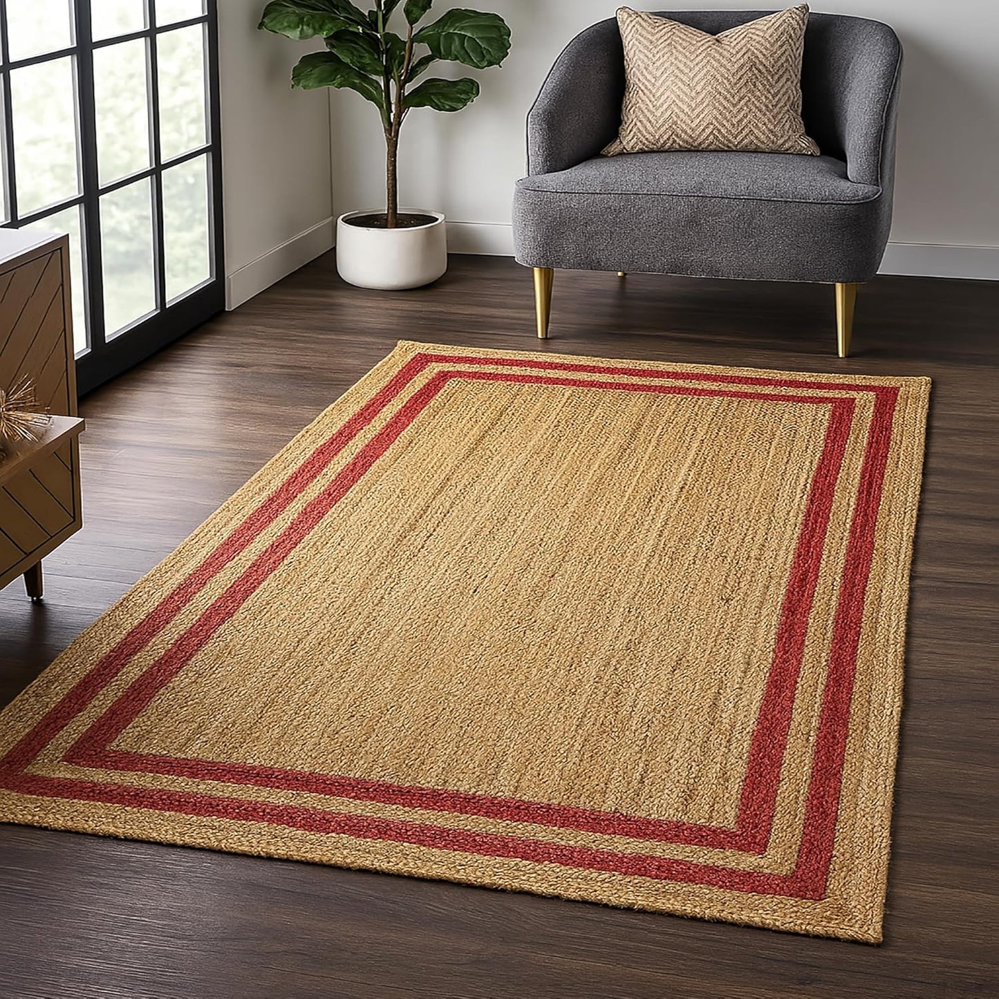 Natural Jute Area Rug with red striped border in a modern living room setting on dark wood flooring
