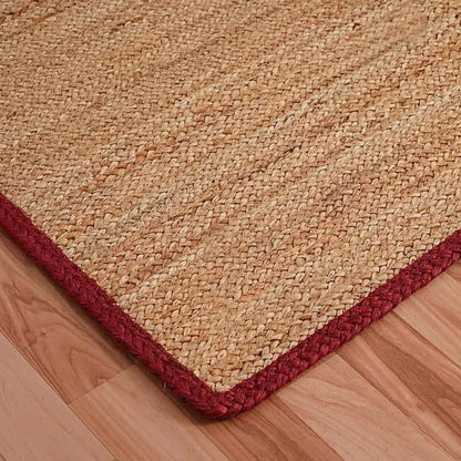 Natural Jute Area Rug floor carpet in natural jute with red border along a square corner