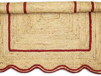 Natural Jute Area Rug with scalloped edges and red border, perfect for entryways or living spaces.