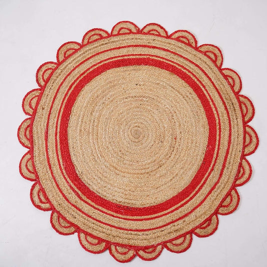 A round woven placemat made of natural jute with red stitched scalloped edges and concentric red stripes, shown flat against a white background.