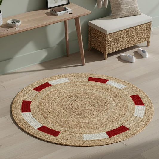 Round natural fiber rug with red and white accents, perfect for stylish home decor.