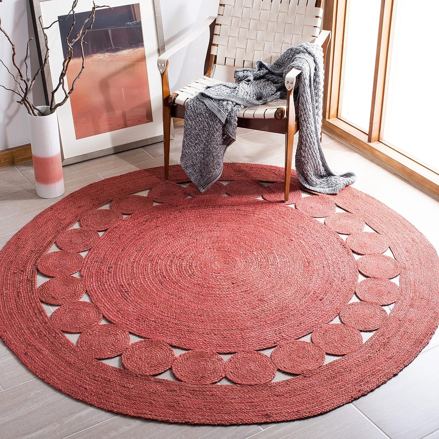 Round red woven area rug with circular cutouts, ideal for home decor and cozy living spaces.