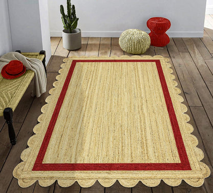 Natural Jute Area Rug with scalloped edges and a vibrant red border, adding warmth to any indoor space.