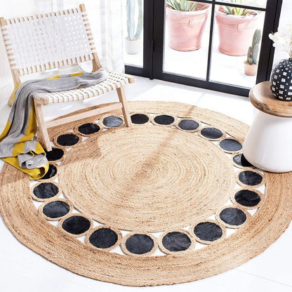 Round jute rug with black circular patterns in a room with a chair and decor.