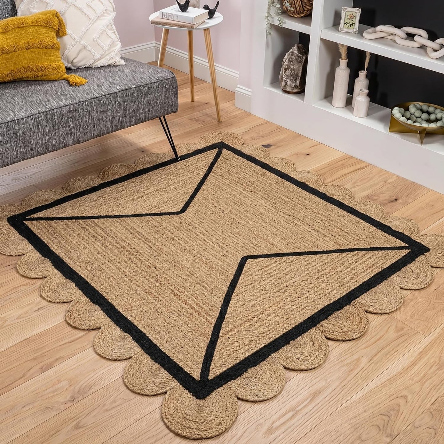 Natural Jute Area Rug with scalloped edges and black border in a cozy living room setting