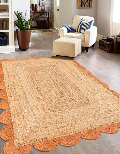 Beige braided rug on a wooden floor with a living room in the background