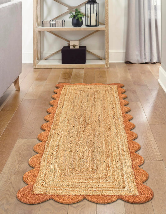 Jute rug with scalloped edges on a wooden floor in a home setting.