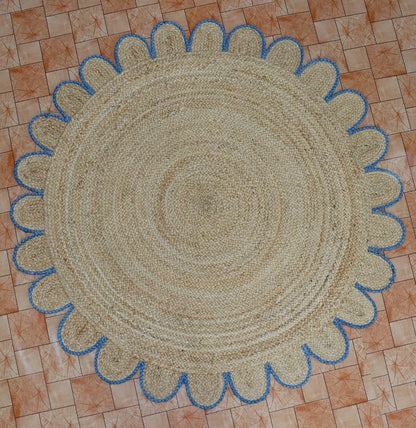 Round braided rug with blue border on a tiled floor