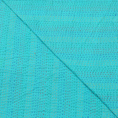 Close-up of turquoise fabric with a subtle pattern