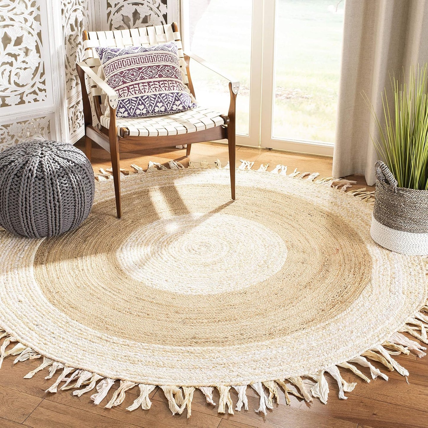 Round woven rug with tassels in a room with a chair and plant