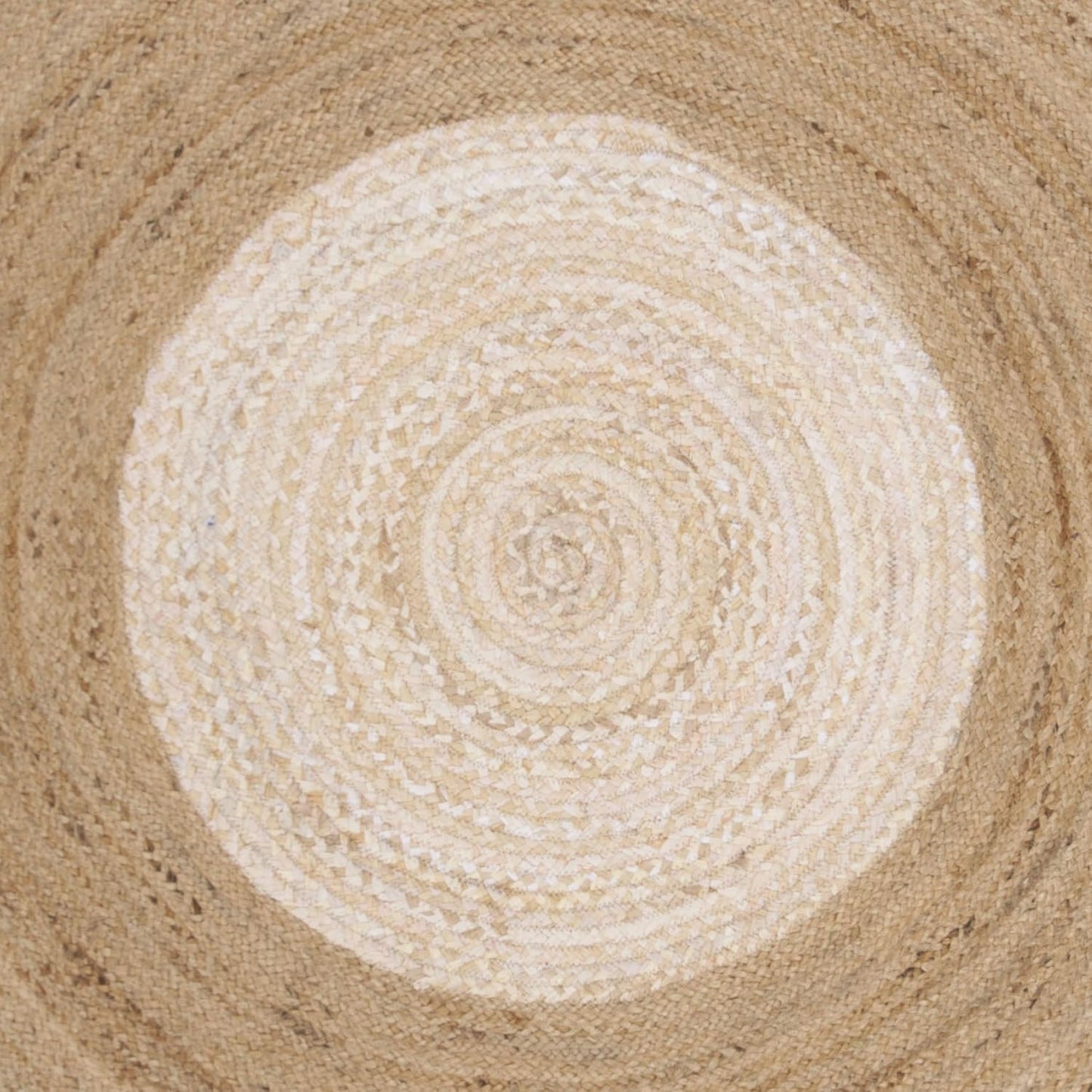 Round woven mat with concentric circle pattern on a textured surface