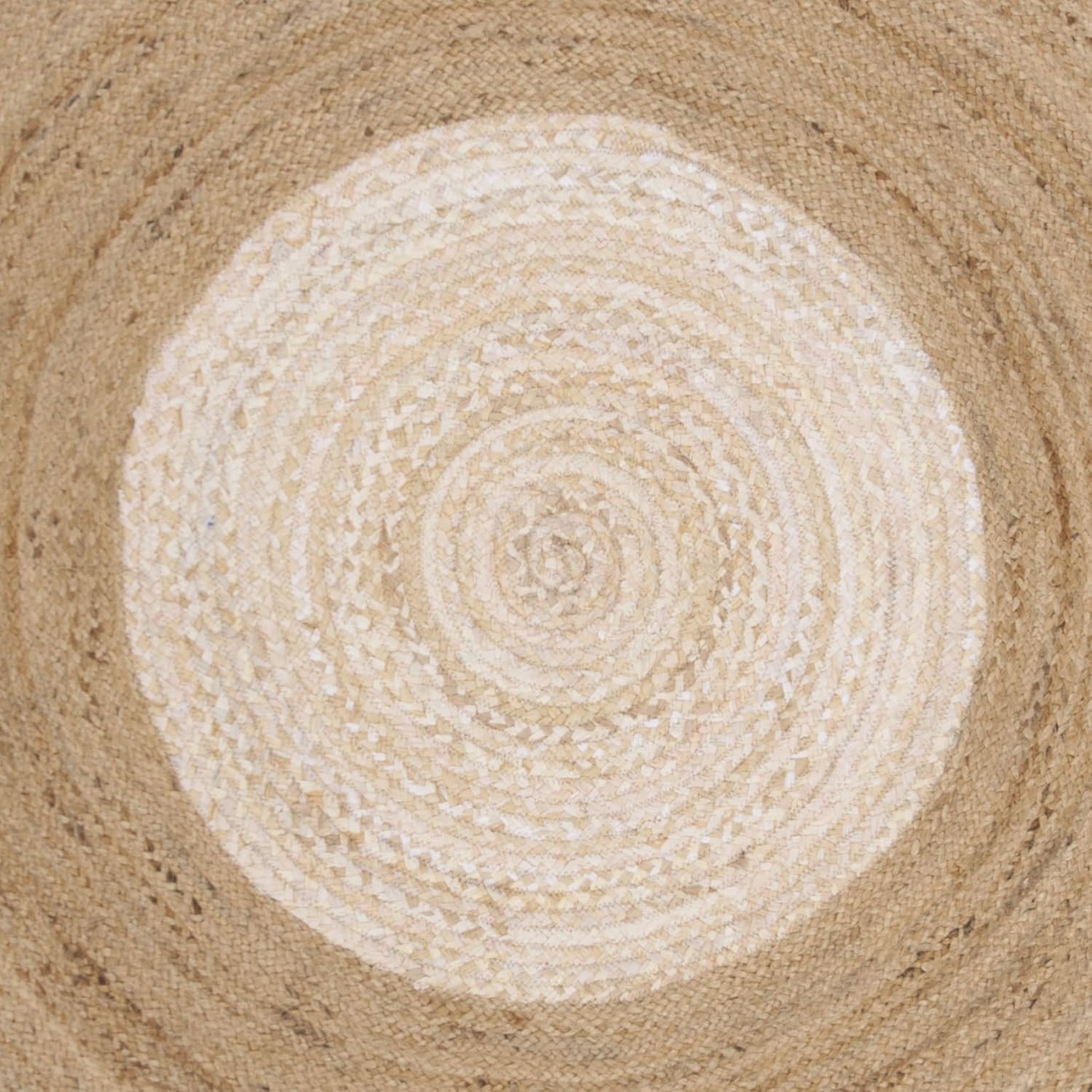 Round woven mat with concentric circle pattern on a textured surface