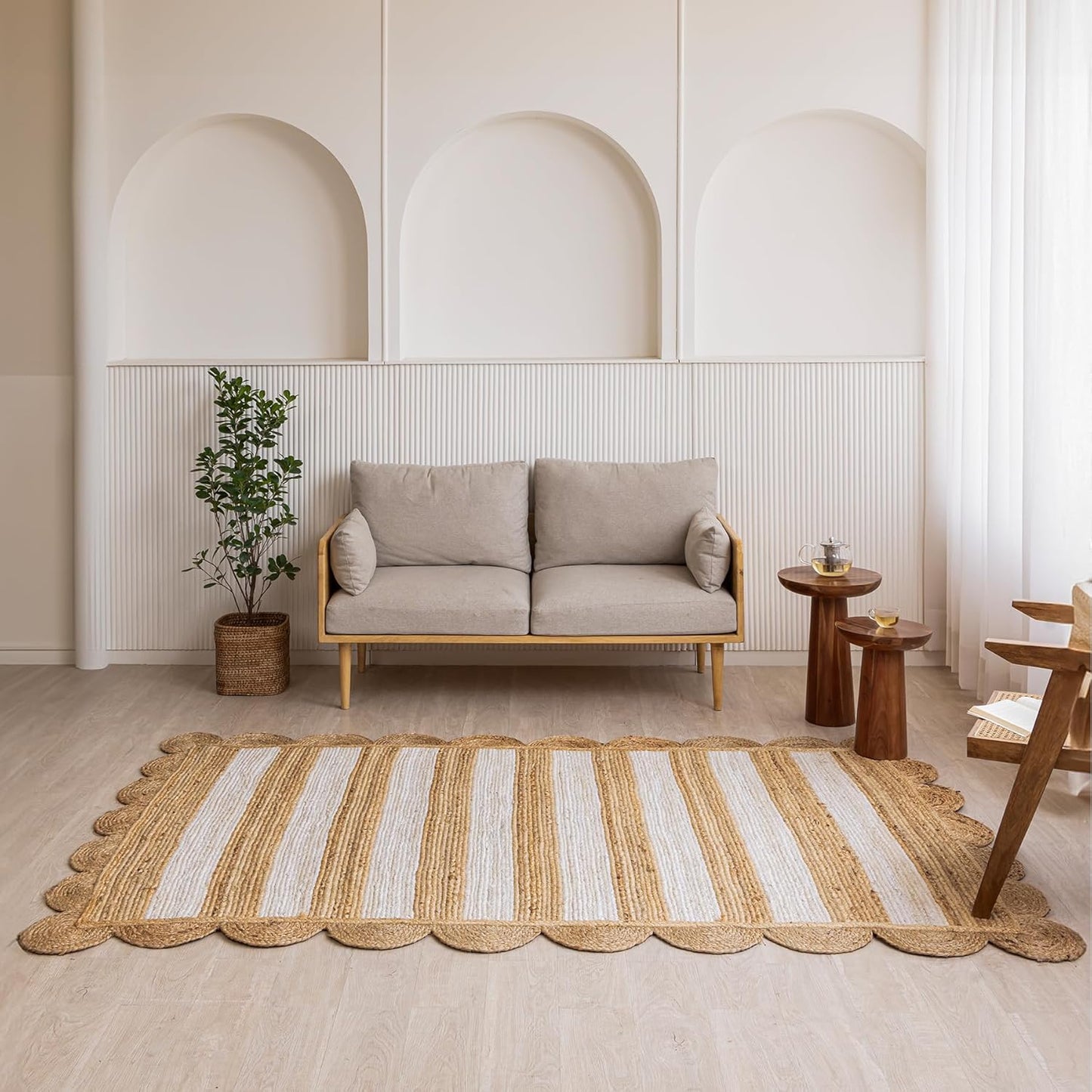 Handmade jute rug, striped in cream and natural hues, perfect for modern living room decor.
