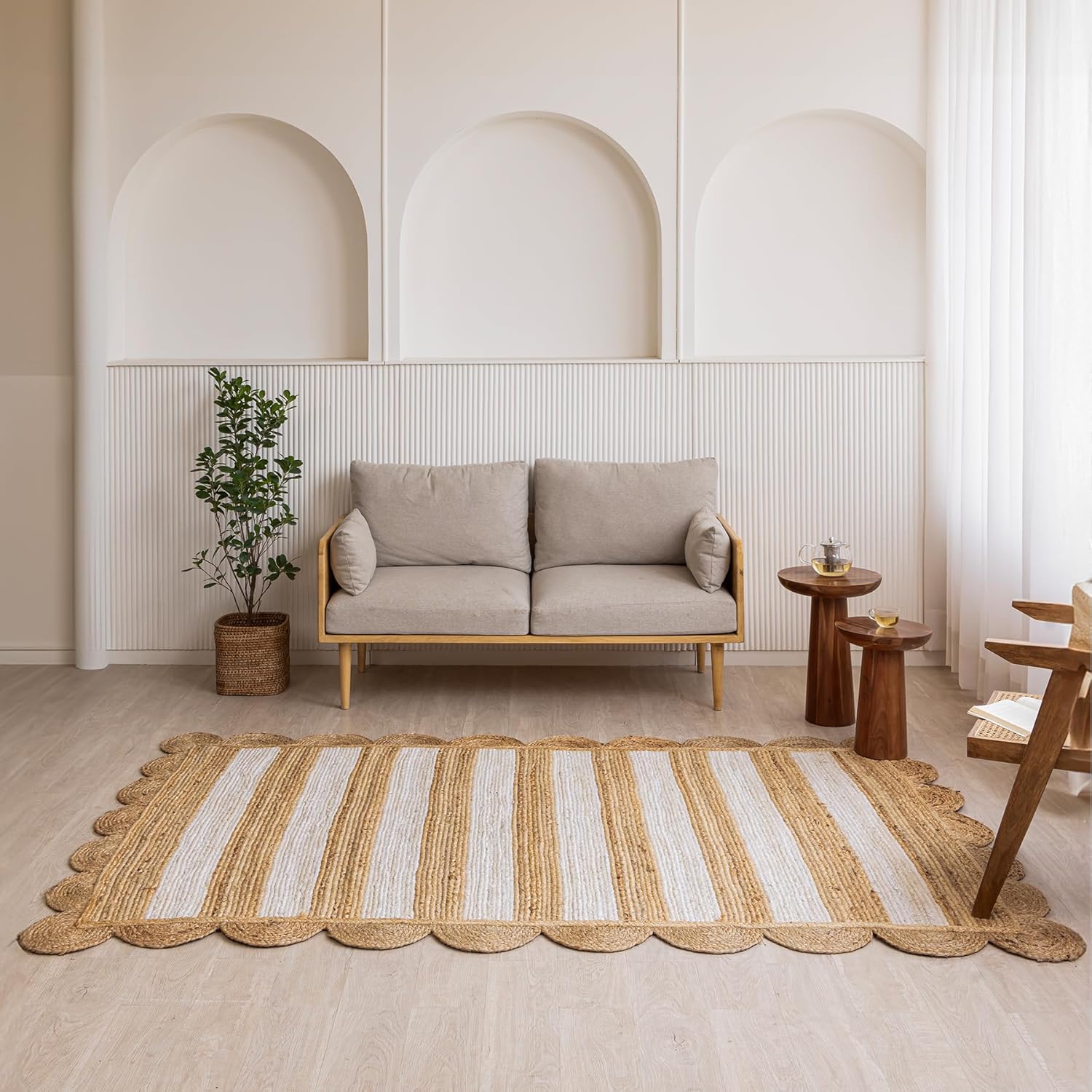 Handmade jute rug, striped in cream and natural hues, perfect for modern living room decor.