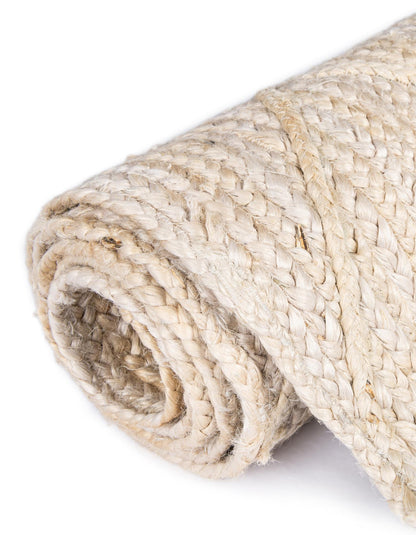 Rolled-up natural fiber rug on a white background