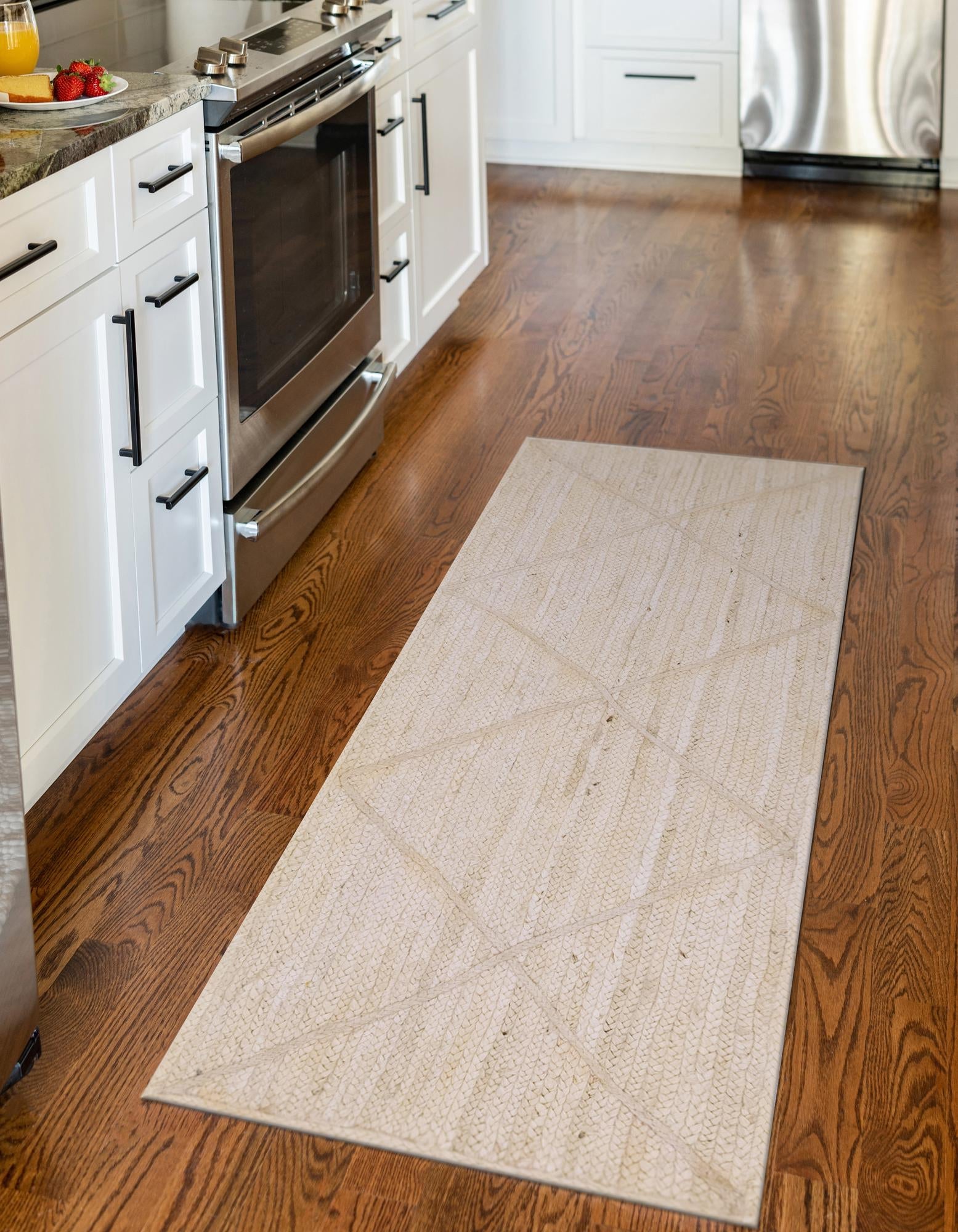 Beige runner rug on a wooden floor in a kitchen setting