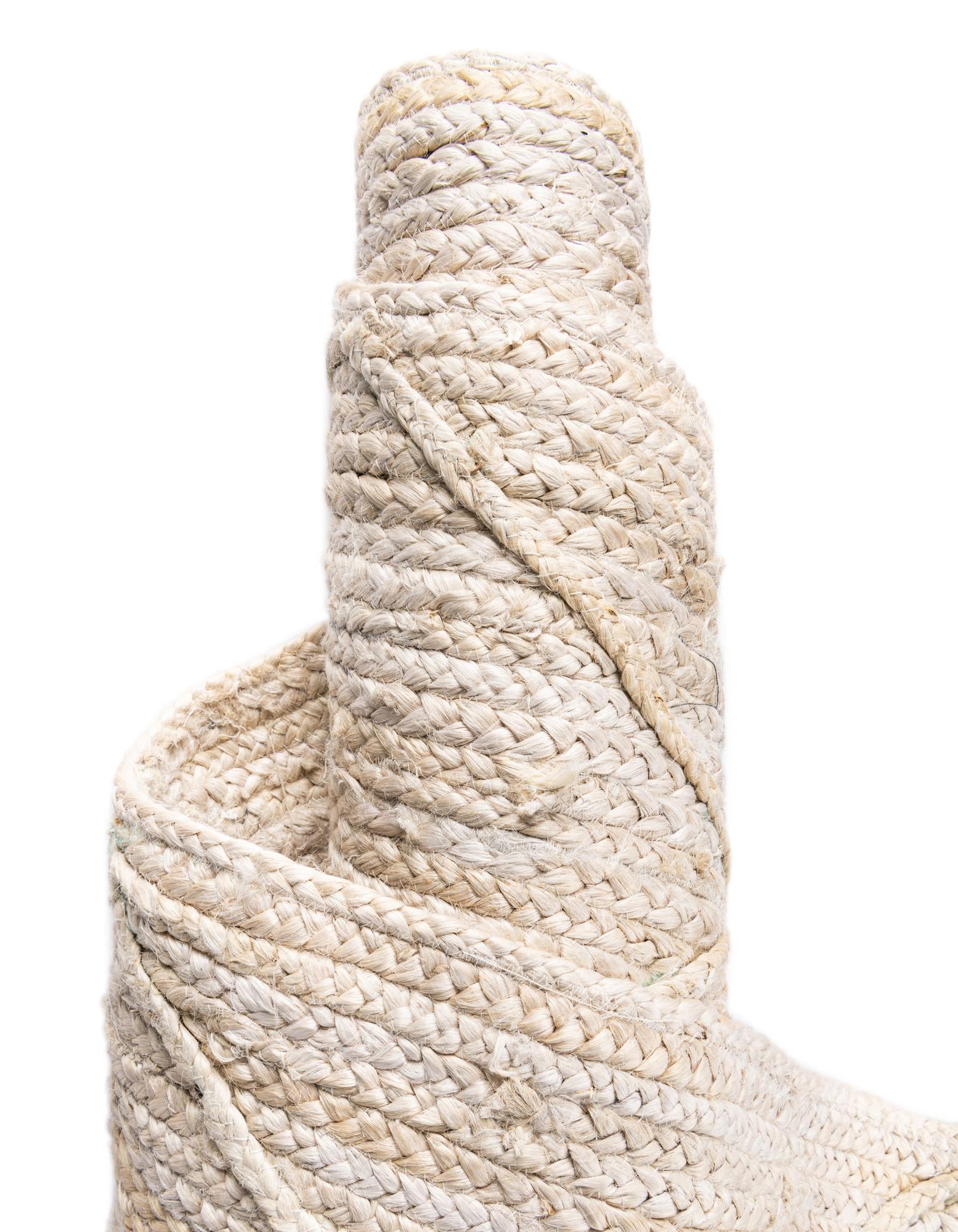 Close-up of a roll of beige rope on a white background