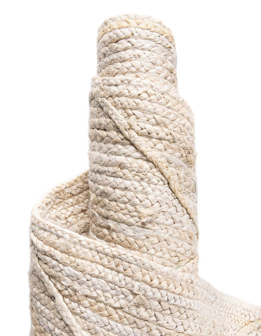 Close-up of a roll of beige rope on a white background