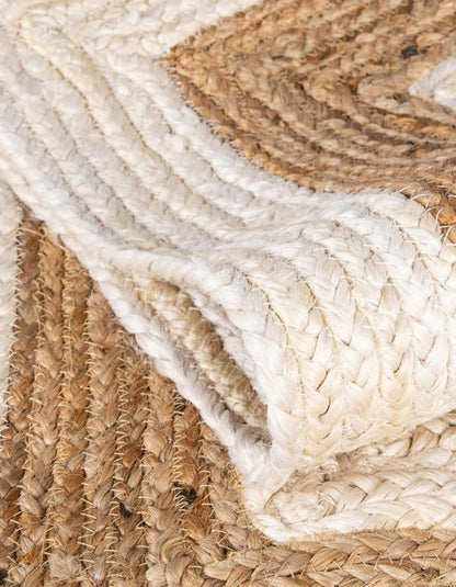 Handwoven jute area rug in natural tones, featuring textured braids and a cozy, rustic design.