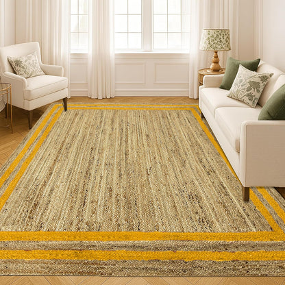 Living room with a large beige rug featuring yellow stripes, white sofa, and armchair.
