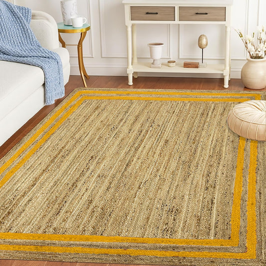 Beige area rug with yellow border in a living room setting