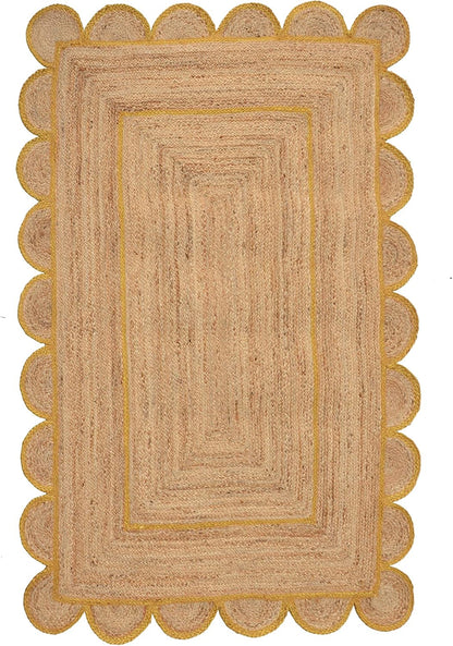 A rectangular natural jute rug with a scalloped border and concentric rectangular pattern, shown flat against a white background.