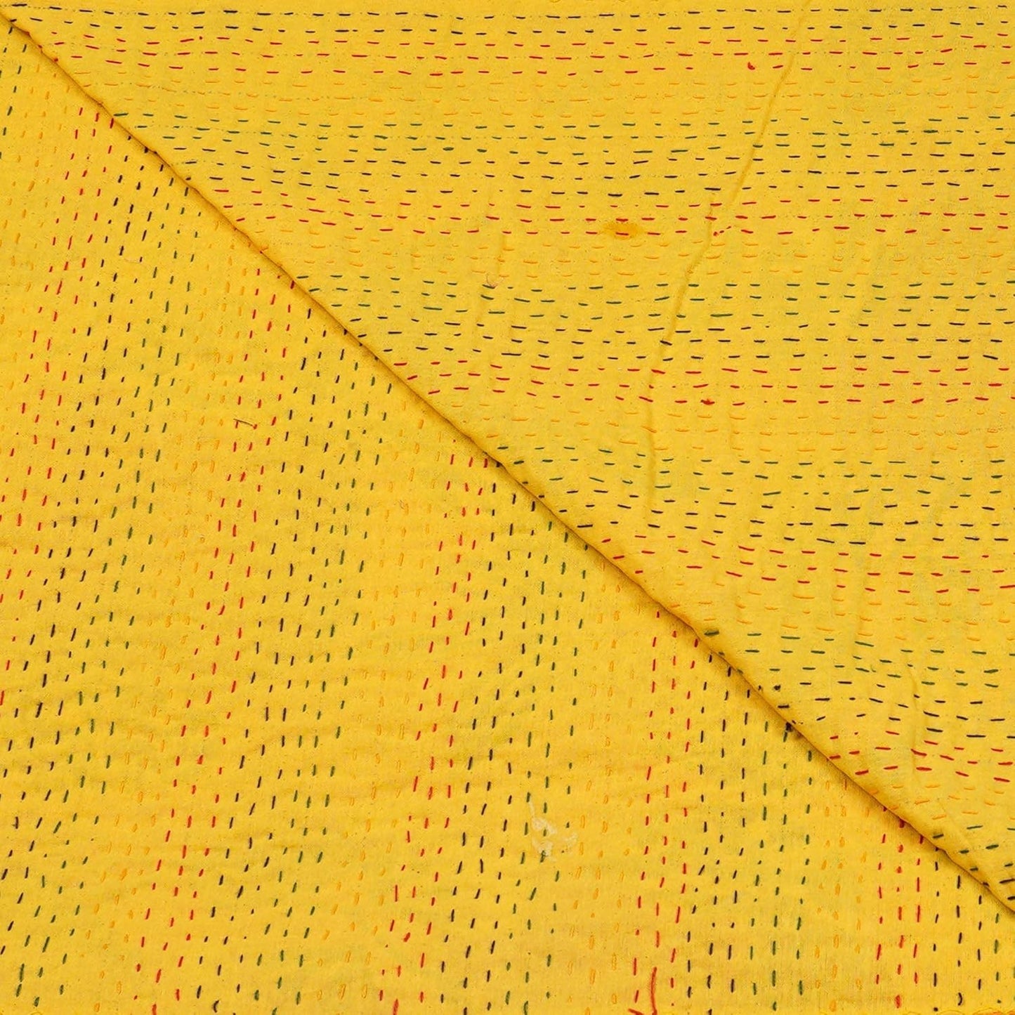 Yellow Kantha bedcover by Handmade, featuring short, colorful stitched detailing and a folded texture.
