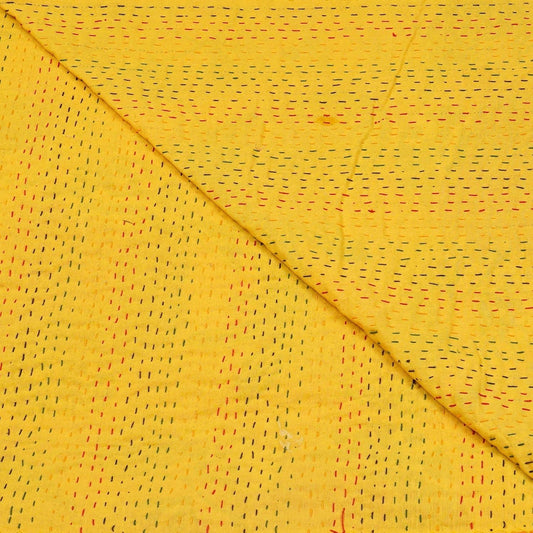 Yellow Kantha bedcover by Handmade, featuring short, colorful stitched detailing and a folded texture.
