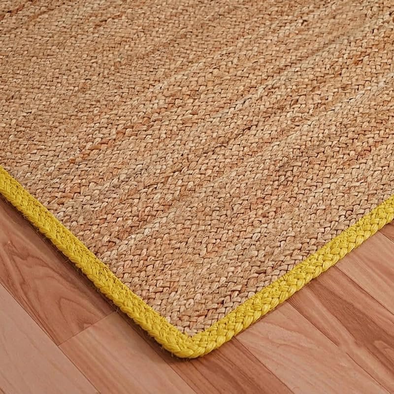 Natural Jute Area Rug beige jute texture with yellow braided edge on wooden floor
