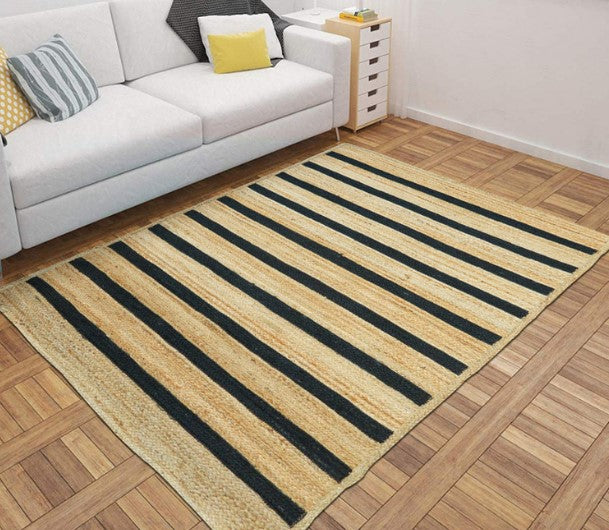 Striped area rug on a wooden floor with a white sofa in the background