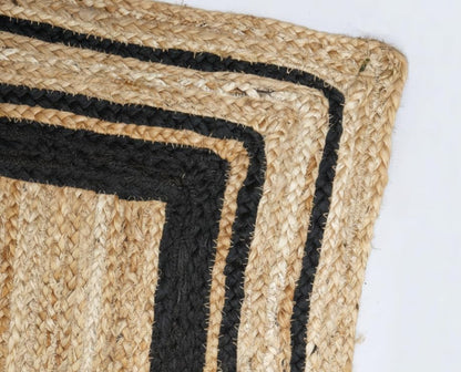 Close-up of a woven mat with black border on a white background