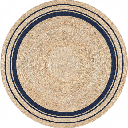 Round beige rug with navy border on a white background