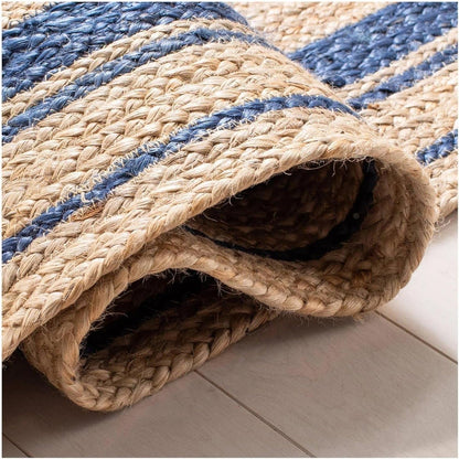 Rolled-up jute rug with blue stripes on a light-colored floor.