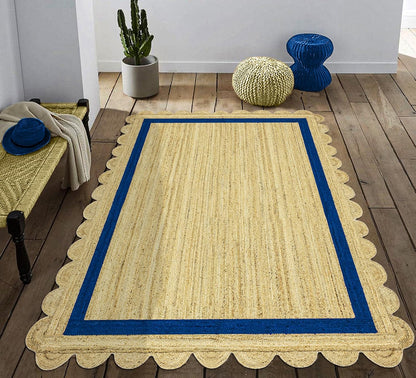 Natural Jute Area Rug with a scalloped edge and blue border, enhancing a cozy indoor space with earthy texture.