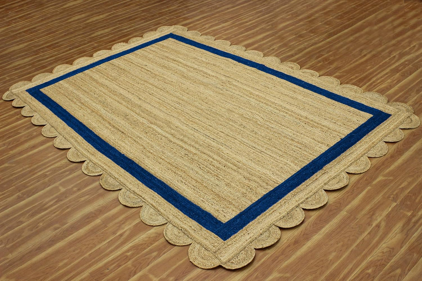 Natural Jute Area Rug with a scalloped edge and blue trim, perfect for enhancing any indoor space.