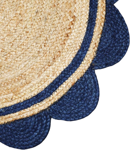 Close-up of a textured blue and beige circular rug.