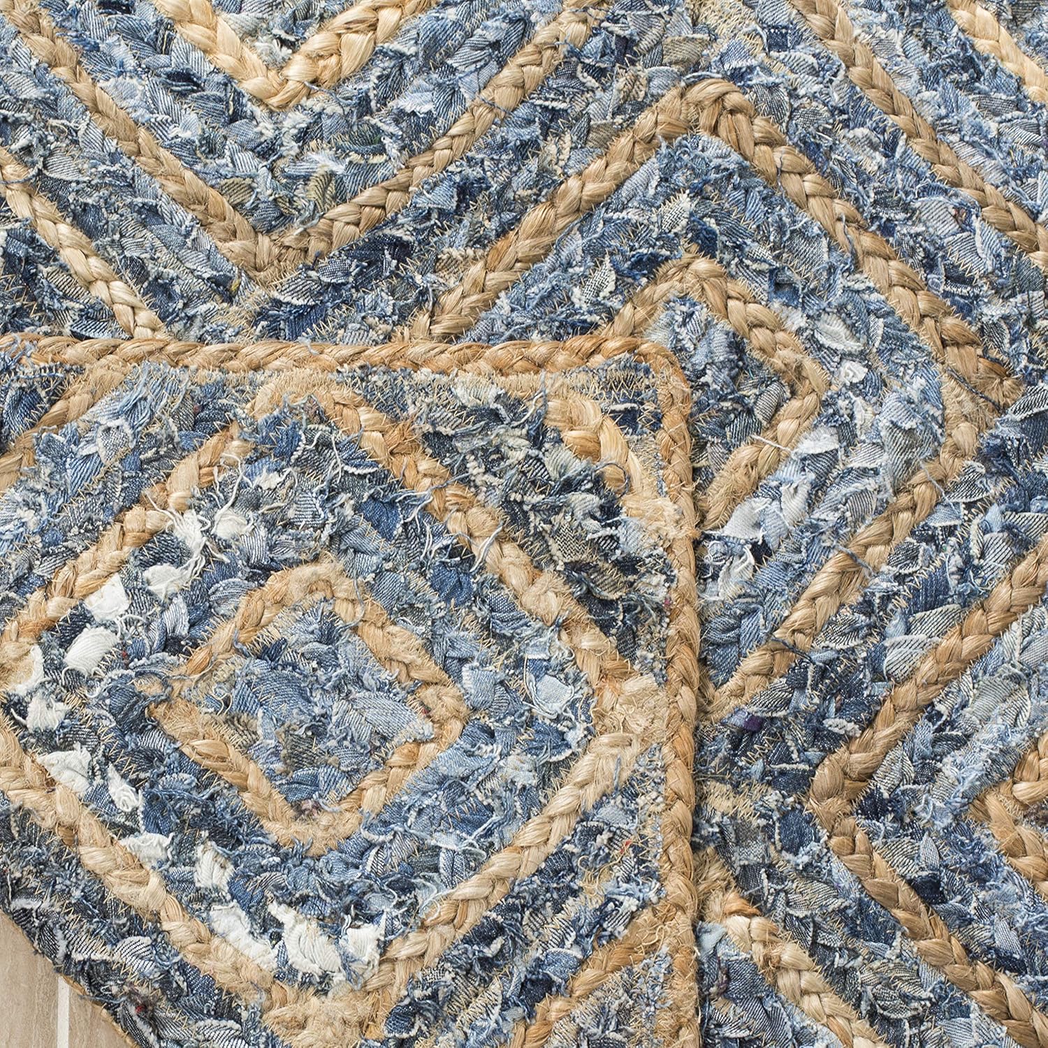 Denim and jute braided rug featuring a blue and beige chevron pattern, crafted from recycled materials.