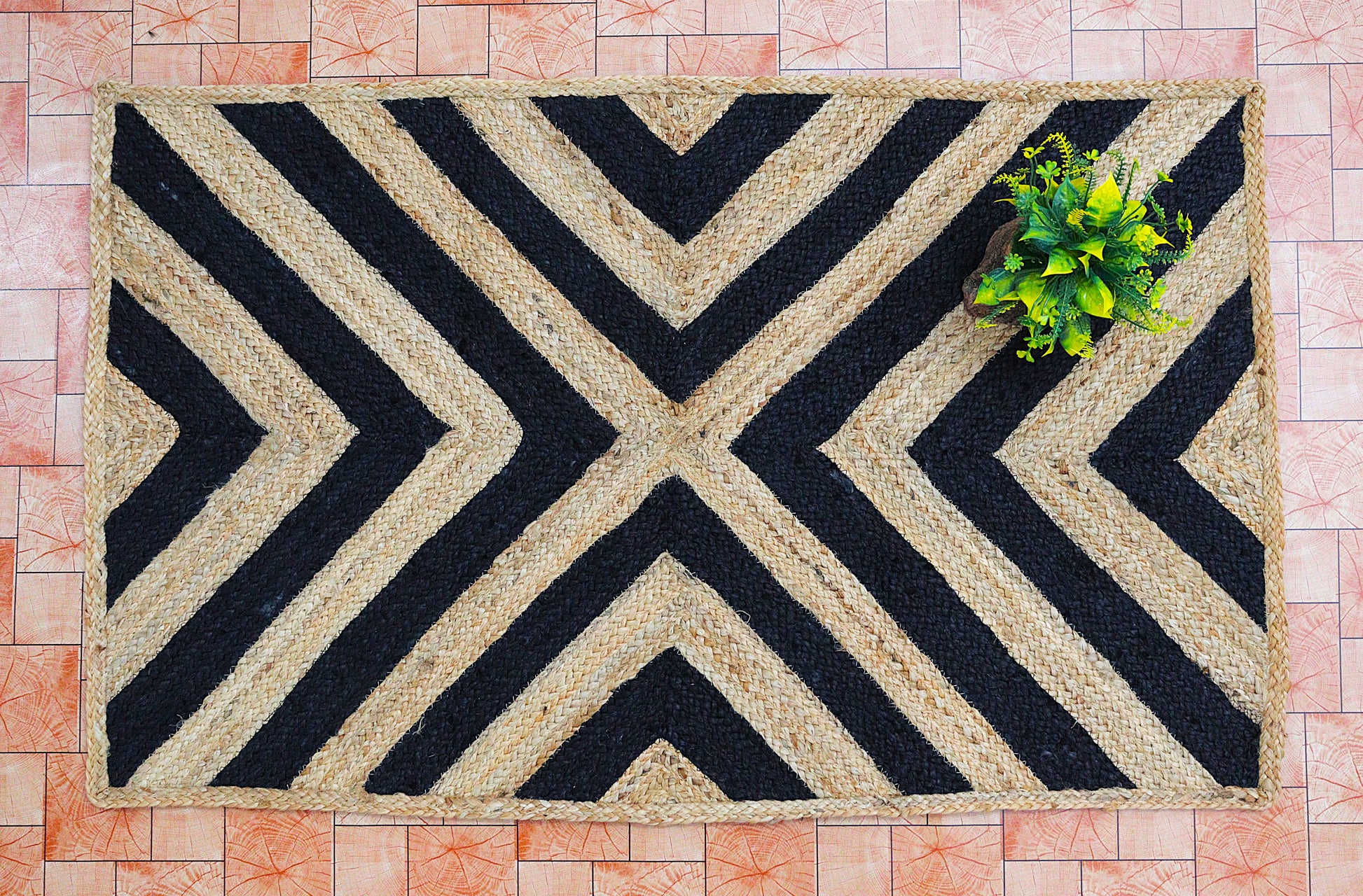 Doormat with black and beige chevron pattern on a tiled floor