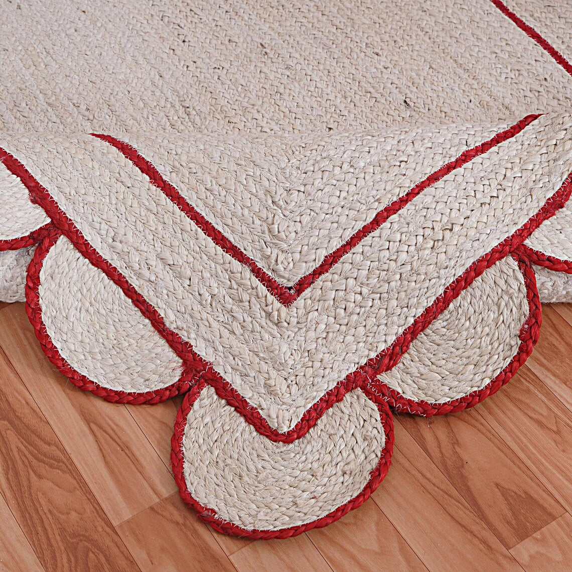 White and red braided rug on a wooden floor