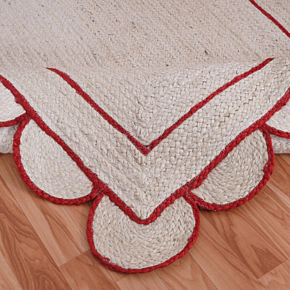 White and red braided rug on a wooden floor
