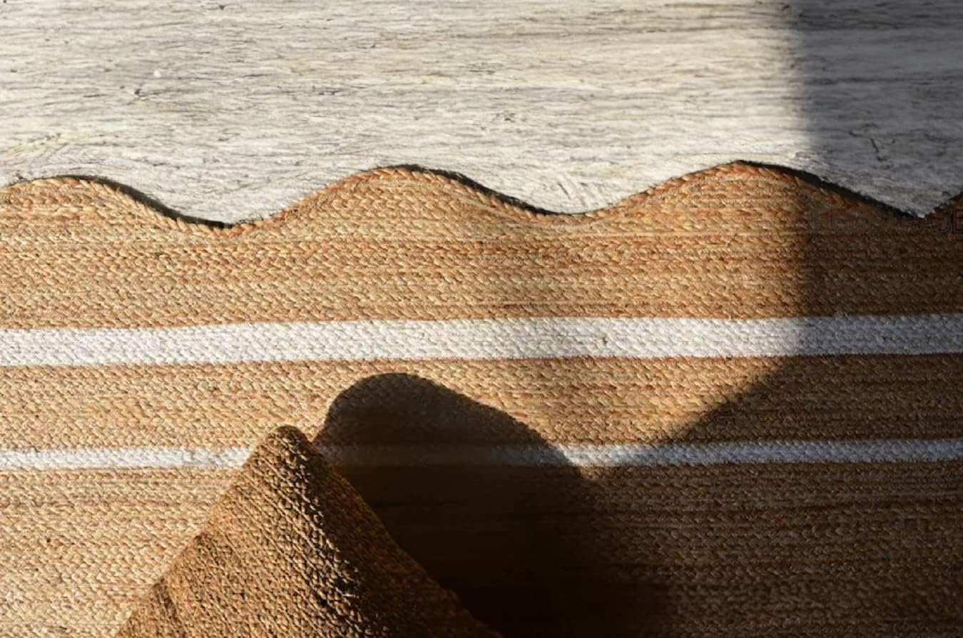 Textured brown and beige woven mat on a wooden floor