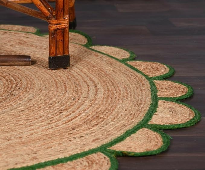 Close-up of a braided jute rug with a green border on a dark wooden floor.