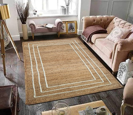 Living room with a beige area rug featuring a white border, pink sofa, and wooden coffee table.