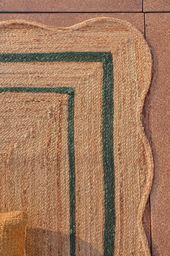 Close-up of a textured rug with a geometric pattern on a wooden floor.